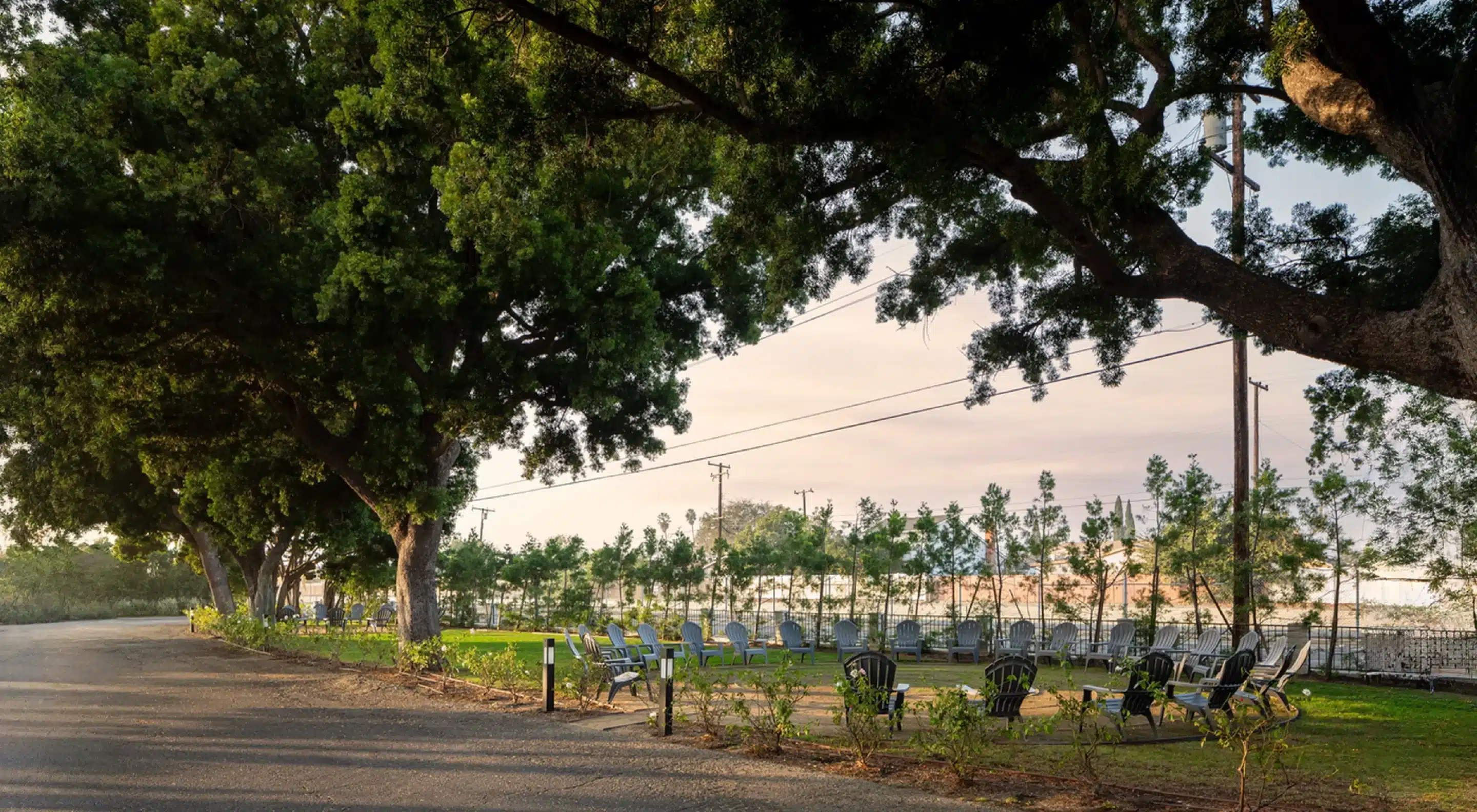 Outdoor reflection space at The Grove — shaded lawn and group seating at dusk on Northbound's Garden Grove campus.
